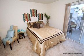 Woodland apartment for rent - a bedroom with a bed and a balcony