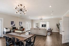 Gulfport apartment for rent - A modern dining room with a wooden table and chairs.