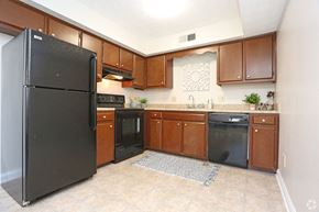 Lexington apartment for rent - a kitchen with black appliances and wooden cabinets