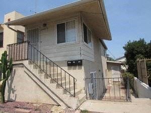 San Diego apartment for rent - A house with a staircase leading to the front door.