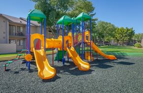 Lancaster apartment for rent - A playground with a yellow slide and green canopies.