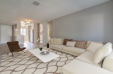 Lancaster apartment for rent - A living room with a white couch and a brown chair.