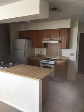 Snyder house for rent - an empty kitchen with a stove and a refrigerator