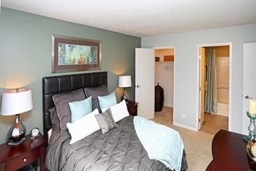 Crystal Lake apartment for rent - a bedroom with a large bed and a door to a bathroom