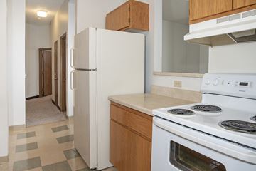 Minneapolis apartment for rent - a kitchen with white appliances and a refrigerator and a stove
