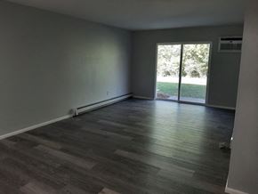 Hartland apartment for rent - A room with a sliding glass door leading to a green outdoor area.