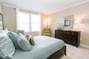 Frederick apartment for rent - bedroom at VistaView apartments in Frederick, MD with bed with blue linens, dresser and chair at VistaView, Maryland, 21702