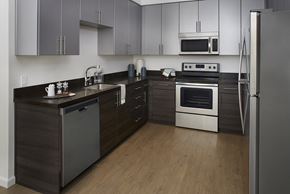 San Jose apartment for rent - San Jose, CA Apartments For Rent - Kitchen With Wood-Plank Flooring, Dishwasher, Oven, Microwave, Refrigerator, Quartz Countertops, And Two Tone Cabinetry.