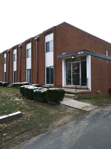 Cuyahoga Falls apartment for rent - A red brick building with the number 1634 on the front.