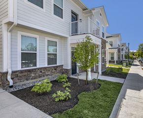 Annandale apartment for rent - a white house with a sidewalk and a tree in front of it