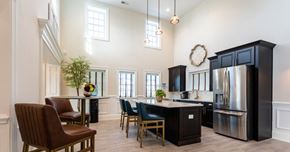 Annandale apartment for rent - a kitchen with a large island with chairs and a refrigerator