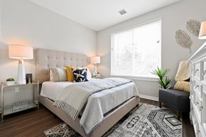 Wynnewood apartment for rent - Spacious bedroom with large window and contemporary furnishings in neutral colors
