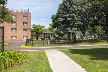 St. Paul apartment for rent - a sidewalk leading to a park with a gazebo and a brick building