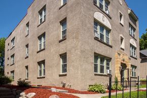 Minneapolis apartment for rent - a large brick building with windows and a sidewalk in front of it