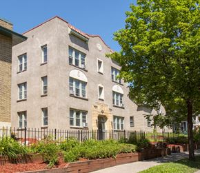 Minneapolis apartment for rent - a large brick building with a tree in front of it