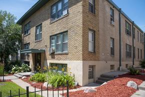 Minneapolis apartment for rent - a brick apartment building with a garden in front of it
