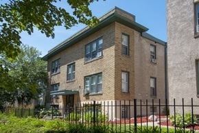 Minneapolis apartment for rent - a brick apartment building with a fence in front of it