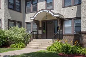 Minneapolis apartment for rent - the front of a building with stairs and a door