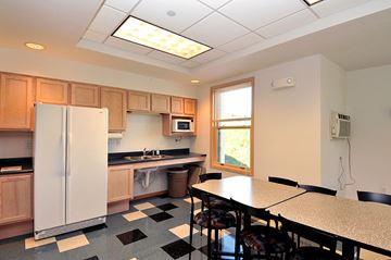 Apple Valley apartment for rent - a kitchen with a table and a refrigerator