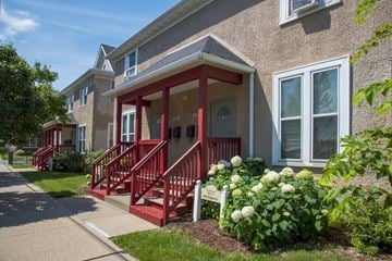 Minneapolis apartment for rent - a red porch in front of a brick apartment building