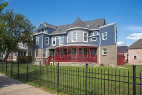 Minneapolis apartment for rent - a blue house with a red porch and a black fence