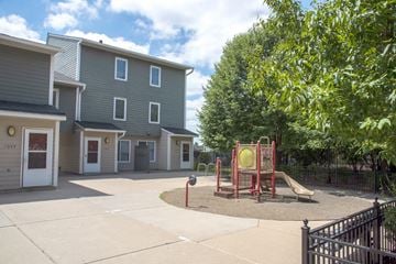 Minneapolis apartment for rent - a playground with a swing set in the middle of a courtyard