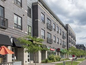 Minneapolis apartment for rent - a large brick building with a red umbrella in front of it
