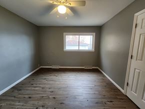 Munster house for rent - an empty bedroom with a window and a ceiling fan