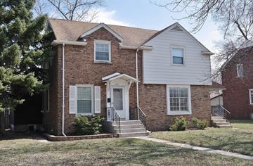 Munster house for rent - the front of a brick house with white siding and a lawn
