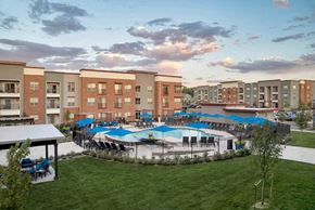 Lakewood apartment for rent - pool with cabanas and green space surrounded by apartments
