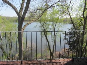 Hudson apartment for rent - a balcony with a view of a lake and trees