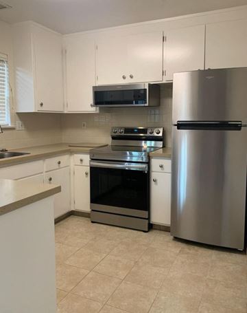 Menlo Park apartment for rent - A kitchen with white cabinets and a stainless steel refrigerator.