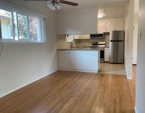 Menlo Park apartment for rent - A kitchen with white cabinets and a wooden floor.
