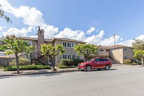 Menlo Park apartment for rent - A red car is parked in front of a two-story apartment building.