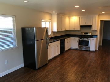 San Jose apartment for rent - a kitchen with white cabinets and a stainless steel refrigerator