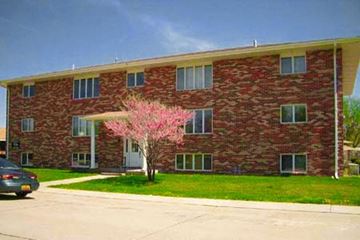 Kearney apartment for rent - a red brick building with a pink tree in front of it