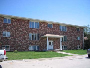 Kearney apartment for rent - a red brick apartment building with a car parked in front