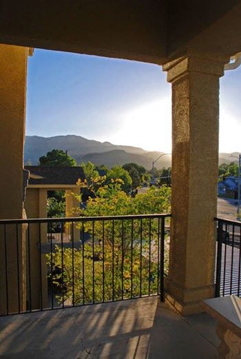 A balcony with a view of a mountain range.