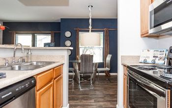 A kitchen with a stove top oven and a sink.