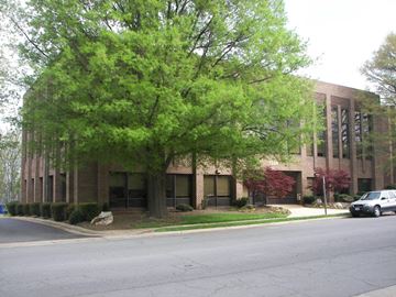 Mclean apartment for rent - A tree in front of a building with a car parked in front of it.