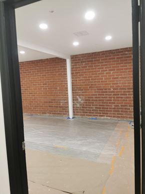 North Hollywood apartment for rent - A room with a brick wall and a white pipe.