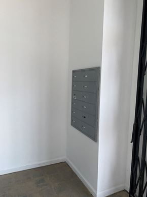 North Hollywood apartment for rent - A metal filing cabinet with drawers is mounted on a white wall.