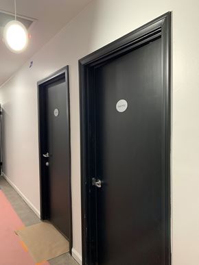 North Hollywood apartment for rent - Two black doors with round handles and a small white sticker on the right door.