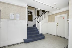 San Francisco apartment for rent - A hallway with a staircase and a door.
