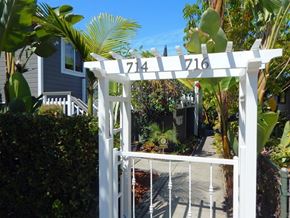 Santa Barbara apartment for rent - A white gate with the numbers 716 on it is in front of a house.