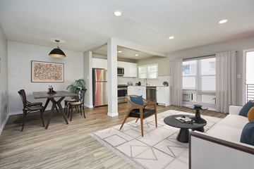 West Hollywood apartment for rent - a living room with a couch and a table with chairs