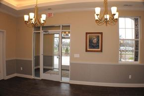 Livonia apartment for rent - an empty dining room with a painting on the wall and chandeliers