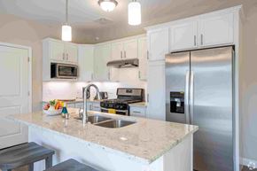 Livonia apartment for rent - a white kitchen with stainless steel appliances and a counter top