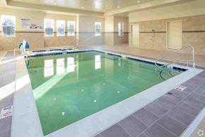 Livonia apartment for rent - a swimming pool with green water and tan tiles