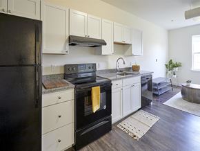 Portland apartment for rent - a kitchen with black appliances and white cabinets